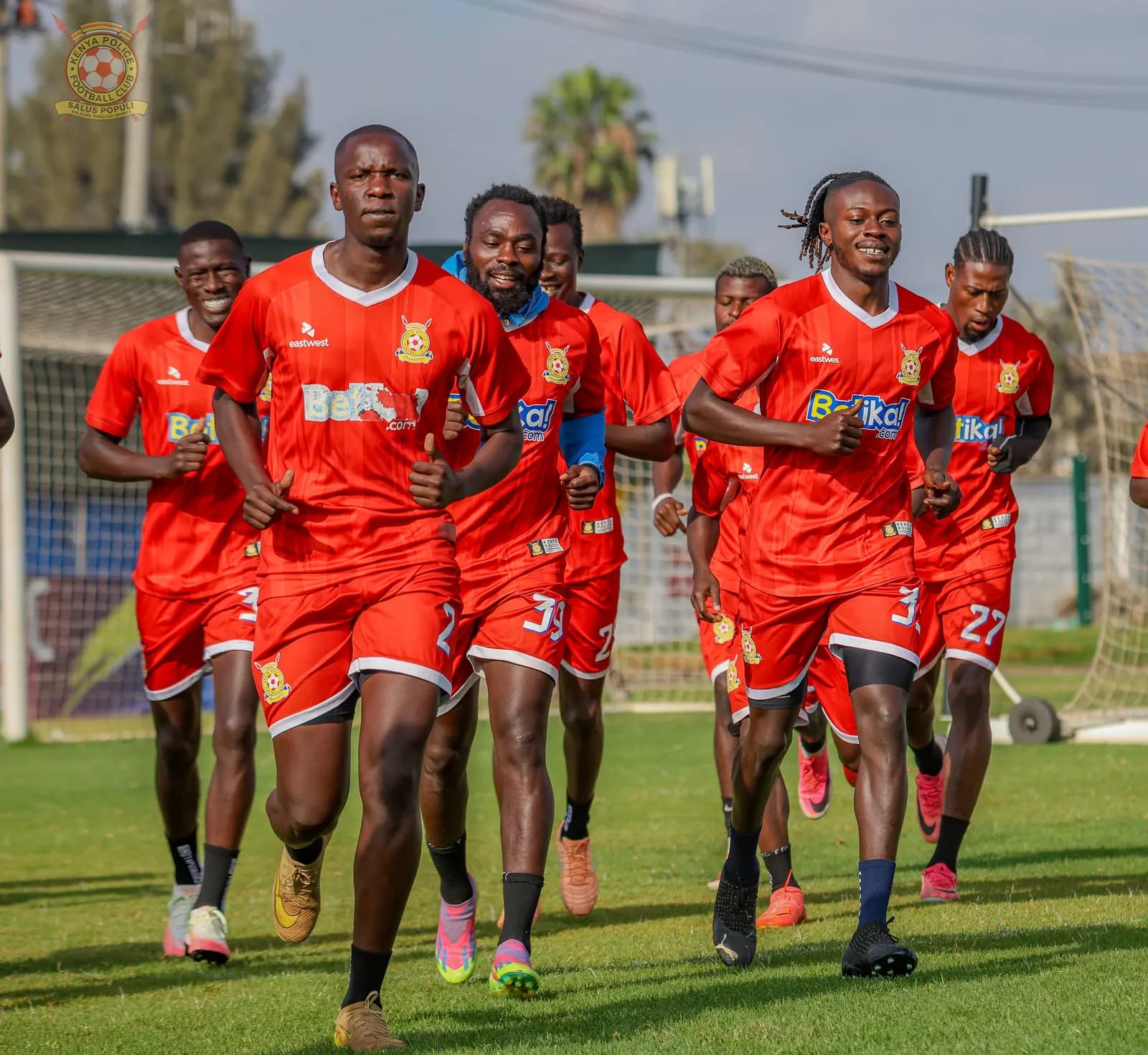 Kenya Police squad running drills in red training kit